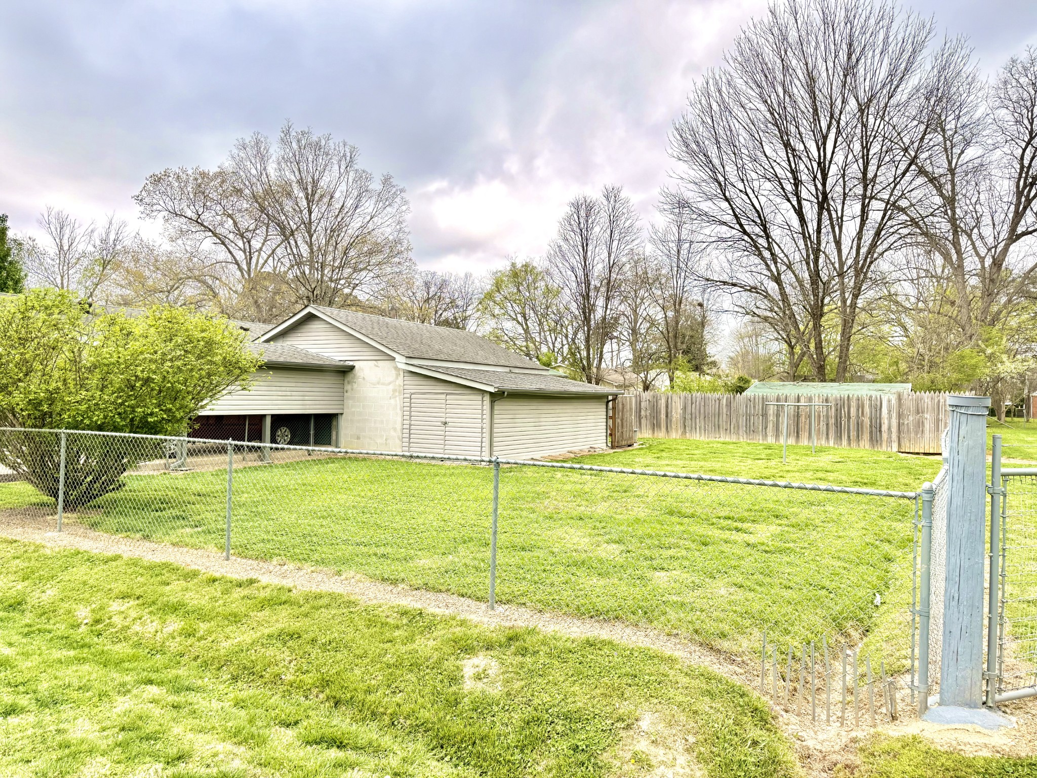 111 Gentry Street Tullahoma, TN 37388 - Photo 6 of 66 a view of a house with a yard and a large tree