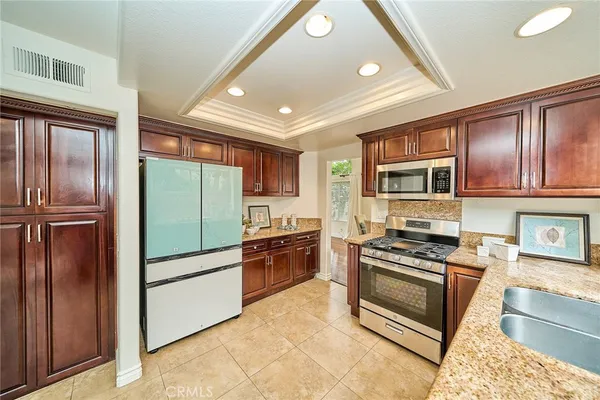 a kitchen with stainless steel appliances granite countertop a refrigerator and stove