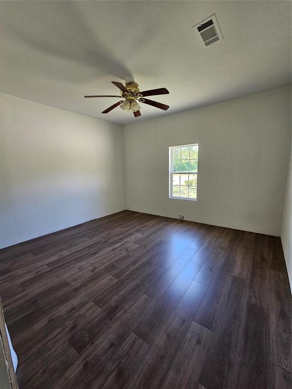 1704 Proctor Avenue Waco, TX 76708 - Photo 19 of 23 a view of an empty room with a window and wooden floor