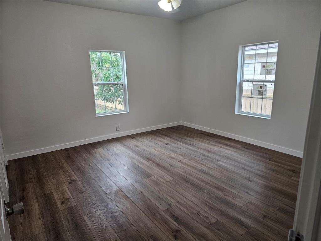 1704 Proctor Avenue Waco, TX 76708 - Photo 20 of 23 an empty room with wooden floor and windows