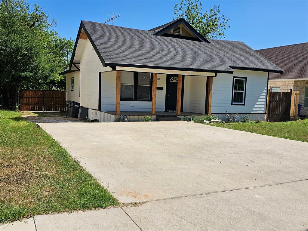 1704 Proctor Avenue Waco, TX 76708 - Photo 2 of 23 a front view of a house with a yard and garage