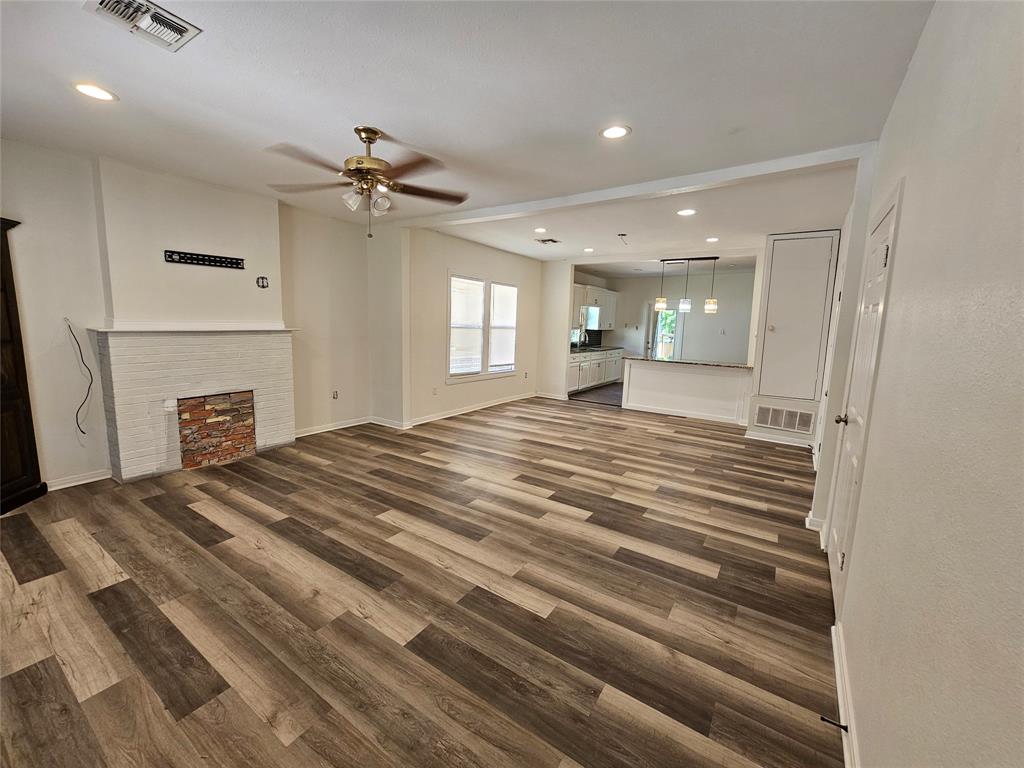 1704 Proctor Avenue Waco, TX 76708 - Photo 6 of 23 a spacious bedroom with a bed and a chandelier