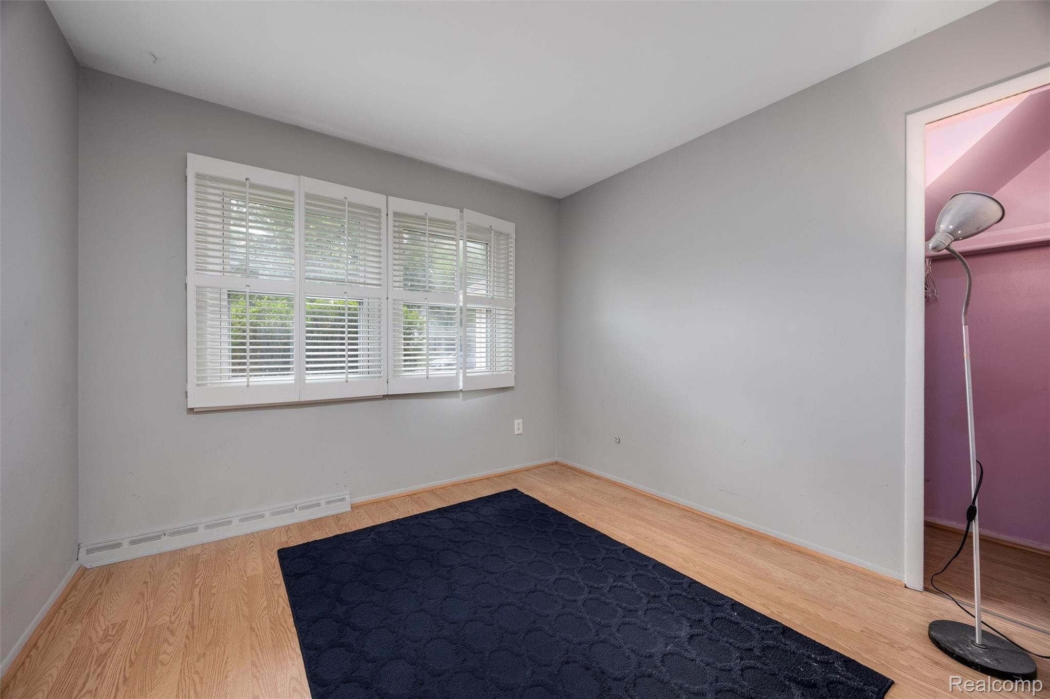 4942 Butler Drive Troy, MI 48085 - Photo 18 of 33 Room featuring light wood-finish flooring, light gray walls, and white window shutters