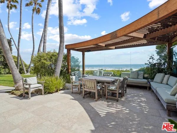 a view of a patio with chairs and a table