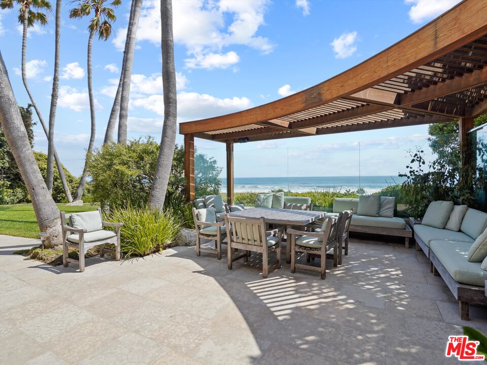31280 Broad Beach Road Malibu, CA 90265 - Photo 12 of 43 a view of a patio with chairs and a table
