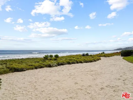 a view of an ocean beach and city