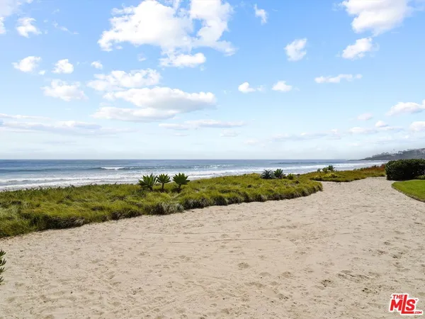 a view of an ocean beach and city