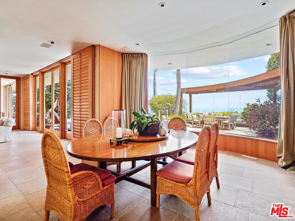 31280 Broad Beach Road Malibu, CA 90265 - Photo 23 of 43 a dining room with furniture and a floor to ceiling window