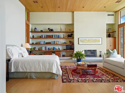 a bed room with a bed and glass table chair