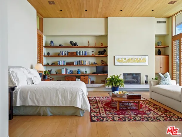 a bed room with a bed and glass table chair