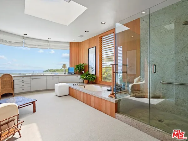 a spacious bathroom with double vanity and a mirror