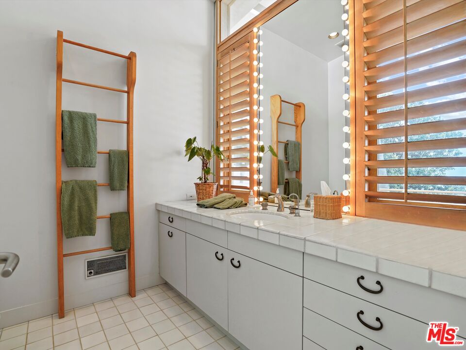 31280 Broad Beach Road Malibu, CA 90265 - Photo 36 of 43 a bathroom with a double vanity sink and a mirror