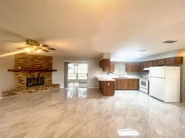 a view of a kitchen with furniture and a fireplace