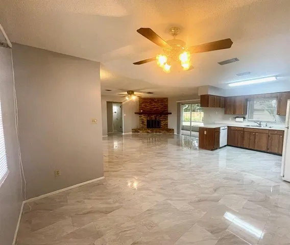 a view of a kitchen with a sink and a window