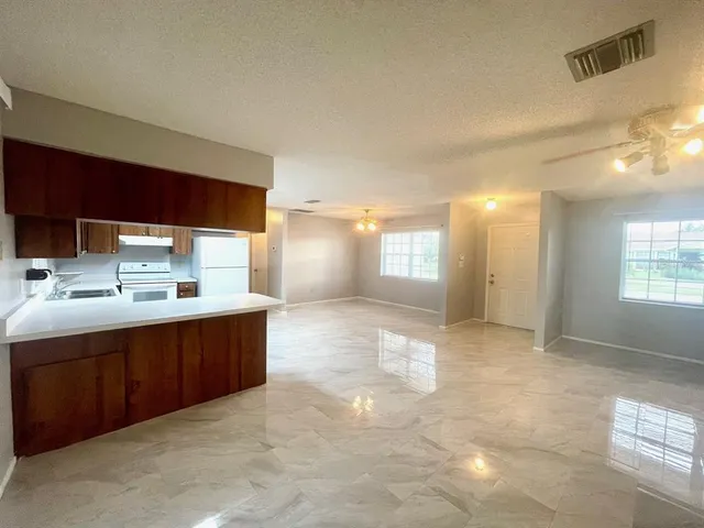 a view of a kitchen with a sink and a window
