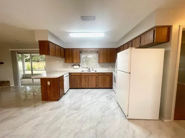 a kitchen with stainless steel appliances a refrigerator and a sink