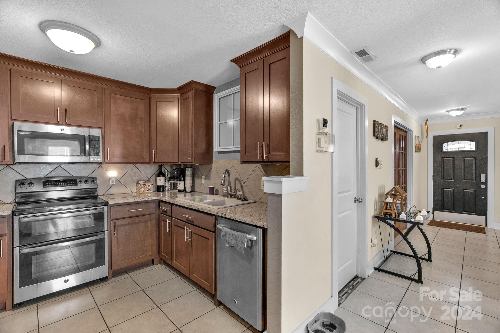 738 Sinclair Drive Monroe, NC 28112 - Photo 12 of 33 a kitchen with stainless steel appliances granite countertop a refrigerator and a sink