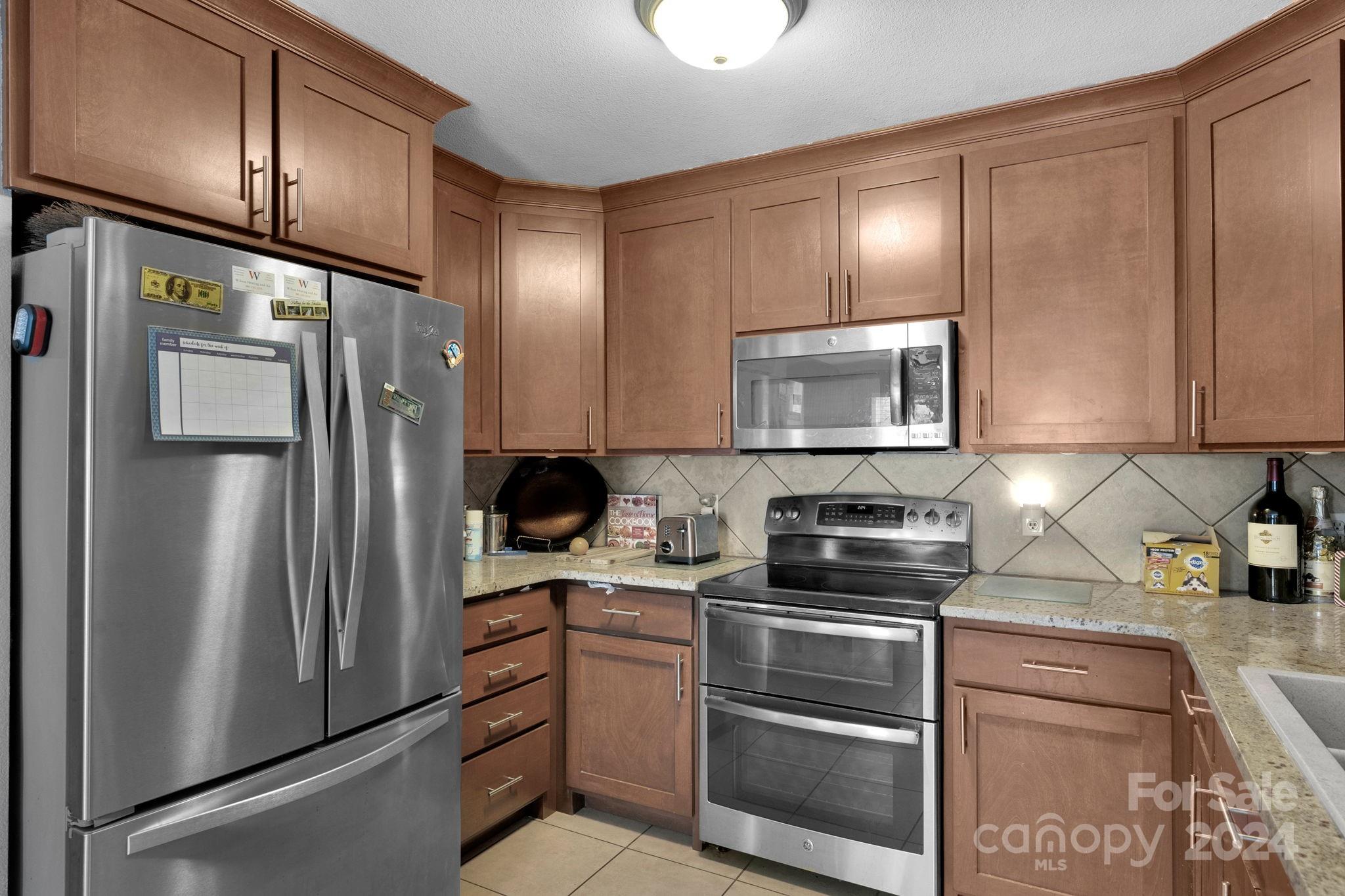 738 Sinclair Drive Monroe, NC 28112 - Photo 14 of 33 a kitchen with a refrigerator stove and sink