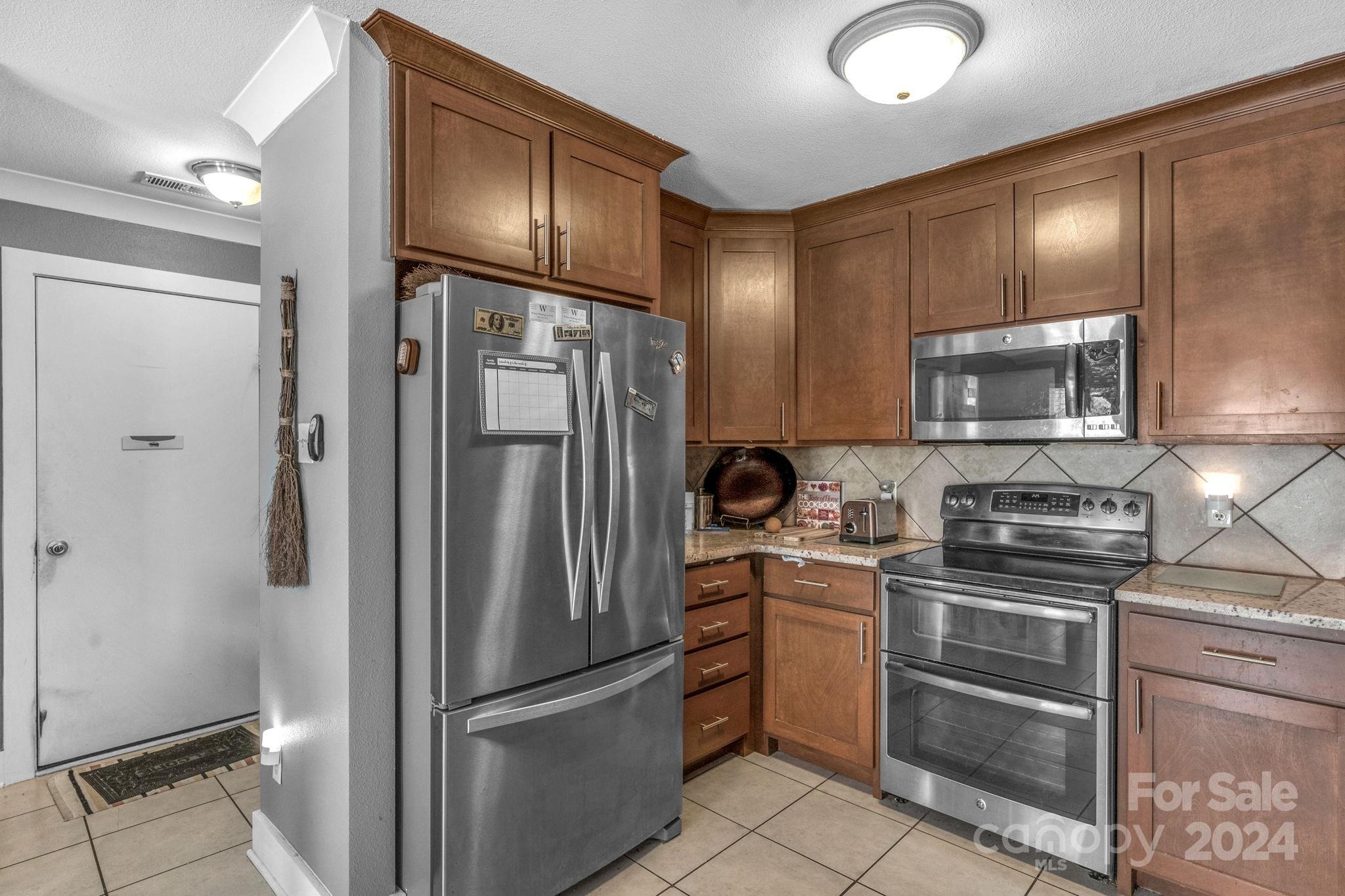 738 Sinclair Drive Monroe, NC 28112 - Photo 15 of 33 a kitchen with stainless steel appliances granite countertop a refrigerator stove and sink