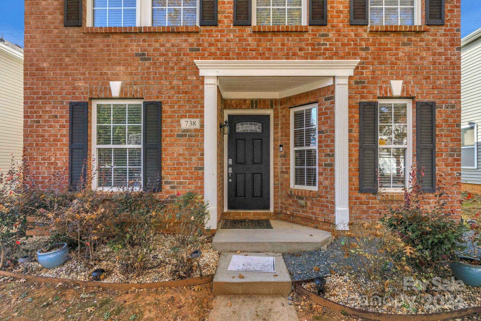 738 Sinclair Drive Monroe, NC 28112 - Photo 2 of 33 a front view of a brick house with a large windows