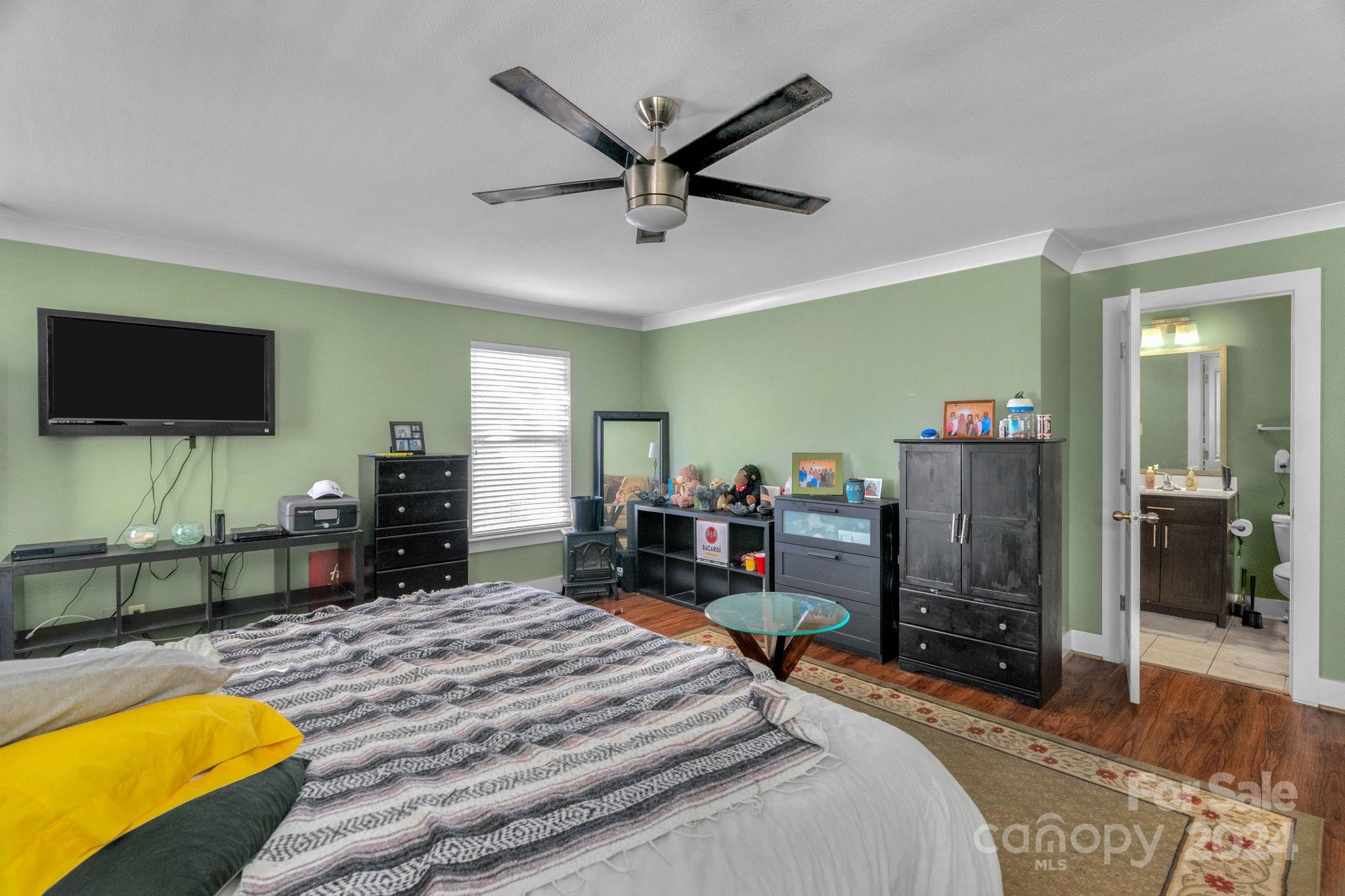 738 Sinclair Drive Monroe, NC 28112 - Photo 24 of 33 a bed room with a bed a television and a large window