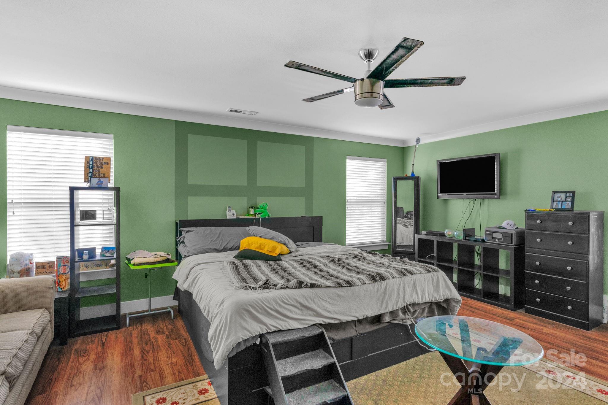 738 Sinclair Drive Monroe, NC 28112 - Photo 25 of 33 a bedroom with a bed a flat screen tv and a couch