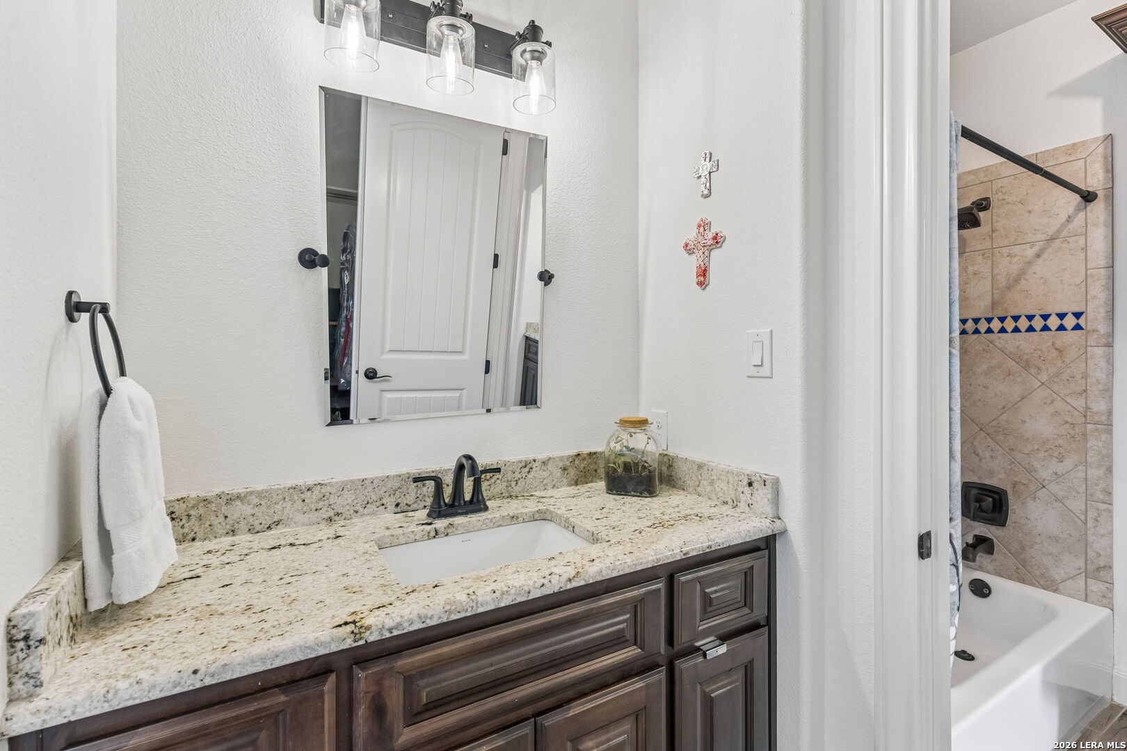 1330 Palmetto Point Spring Branch, TX 78070 - Photo 27 of 43 a bathroom with a granite countertop sink and a mirror