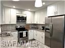3120 Seasons Way, Unit 309 Estero, FL 33928 - Photo 6 of 33 a kitchen with granite countertop a refrigerator and a sink