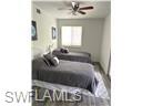3120 Seasons Way, Unit 309 Estero, FL 33928 - Photo 8 of 33 a bedroom with a bed and a window