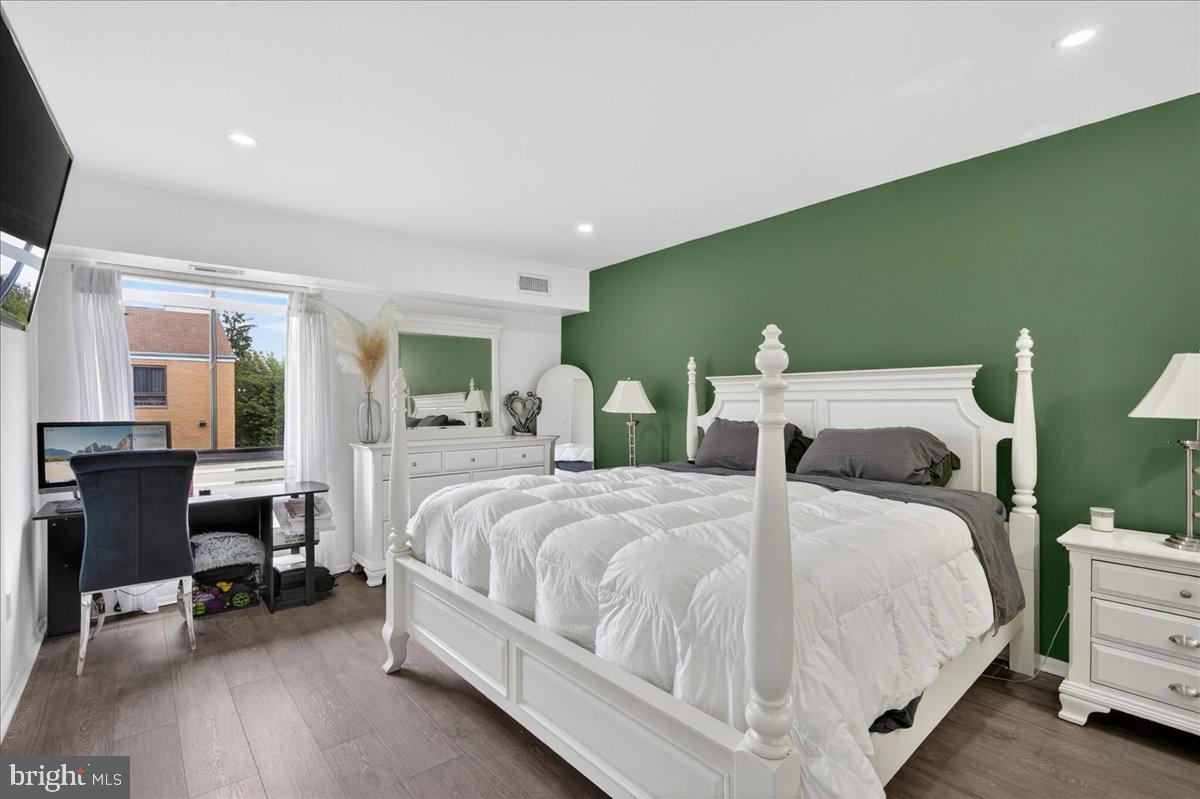 8930 Krewstown Road, Unit 310 Philadelphia, PA 19115 - Photo 15 of 32 a bedroom with a bed and a table