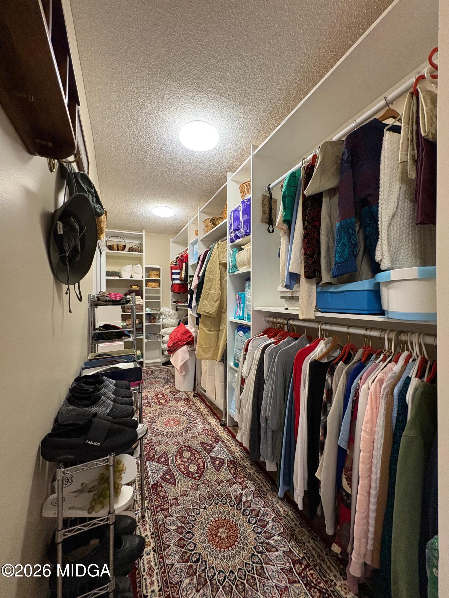 205 White Road Byron, GA 31008 - Photo 16 of 38 a view of walk in closet with clothes and shoes