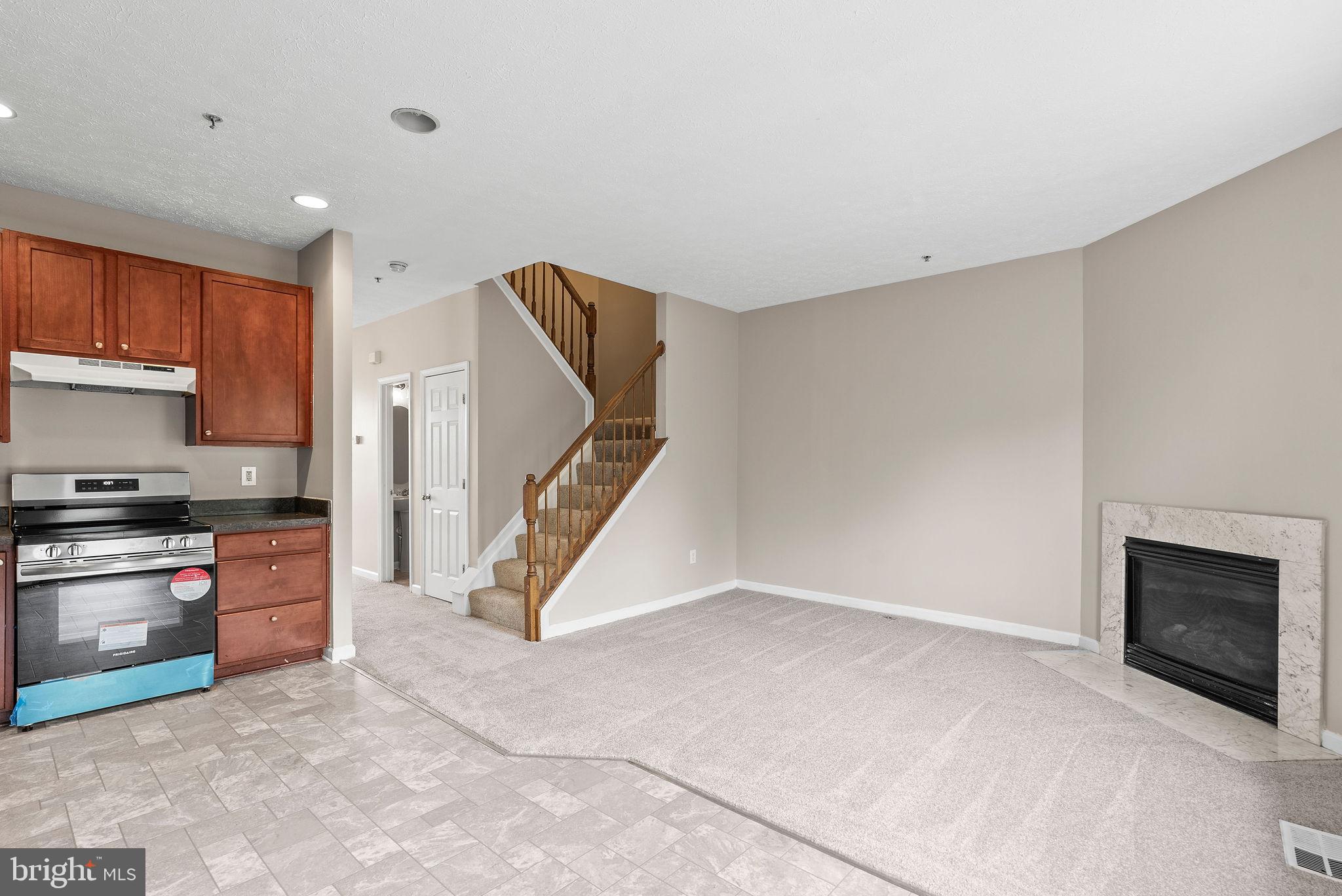 9711 Luguna Road Baltimore, MD 21220 - Photo 17 of 37 a view of a kitchen with a sink oven cabinets and a living room