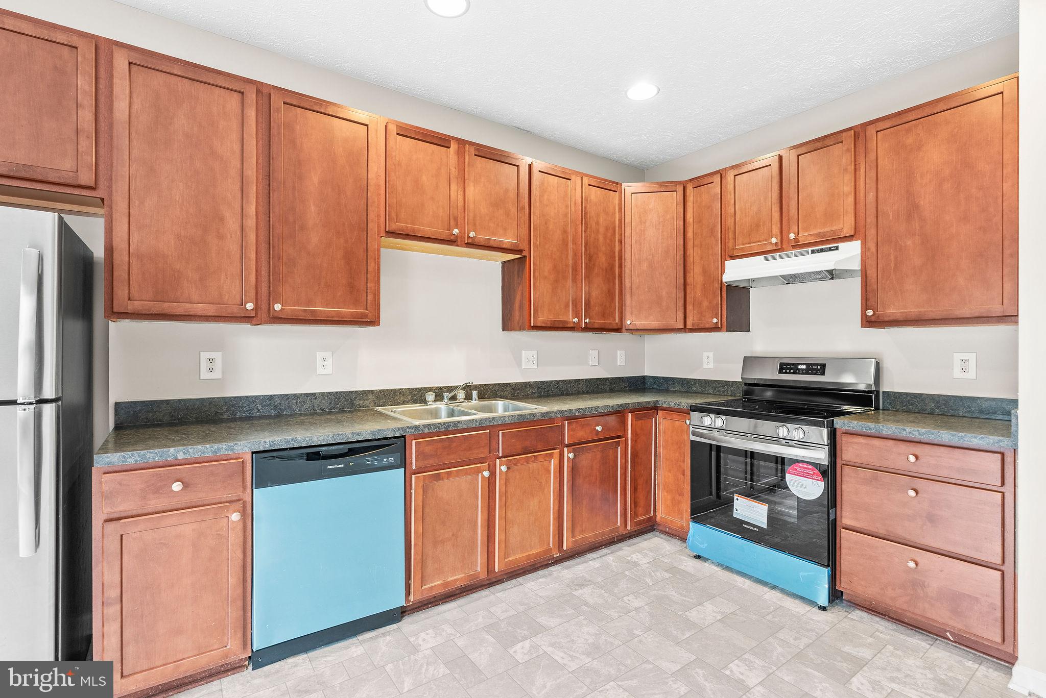 9711 Luguna Road Baltimore, MD 21220 - Photo 18 of 37 a kitchen with stainless steel appliances granite countertop wooden cabinets a sink and a stove