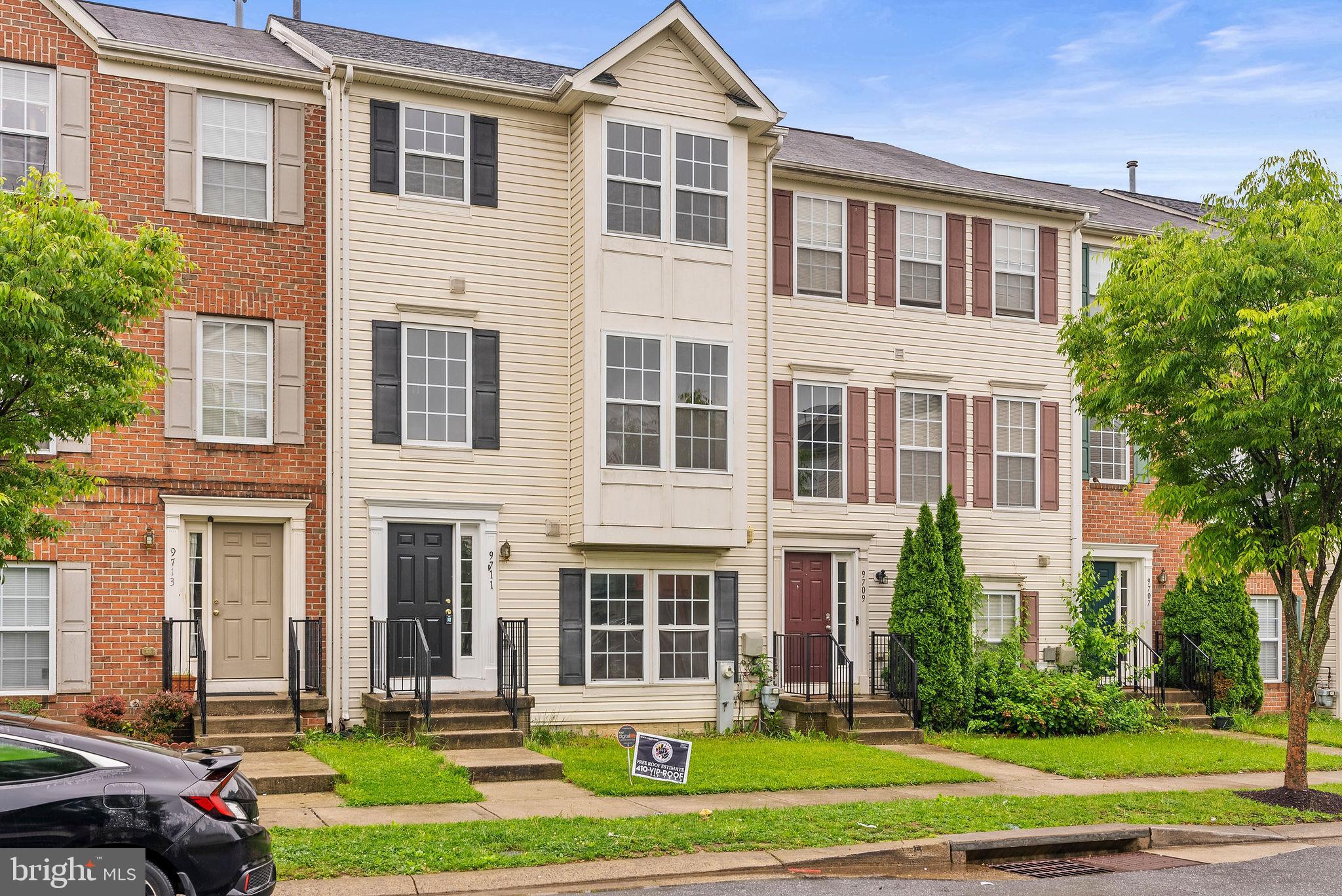 9711 Luguna Road Baltimore, MD 21220 - Photo 2 of 37 a front view of a residential apartment building with yard and green space