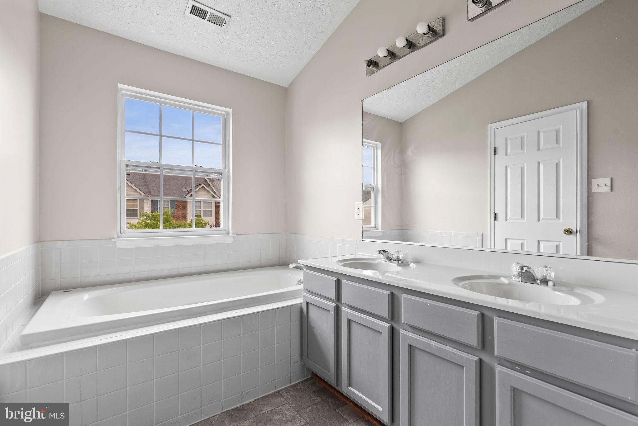 9711 Luguna Road Baltimore, MD 21220 - Photo 26 of 37 a bathroom with a tub sink and mirror