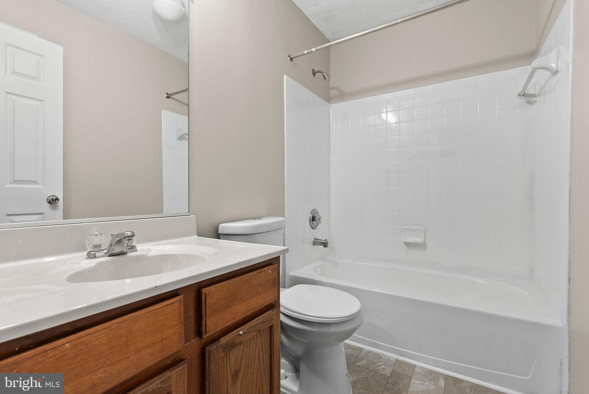 9711 Luguna Road Baltimore, MD 21220 - Photo 28 of 37 a bathroom with a sink a toilet and shower