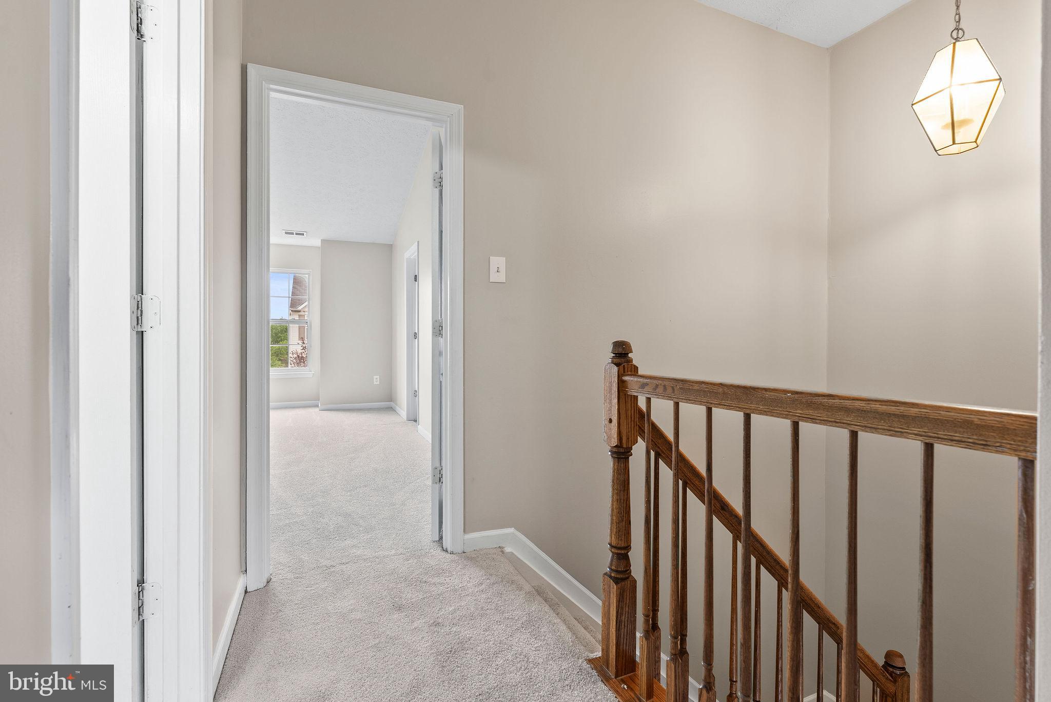 9711 Luguna Road Baltimore, MD 21220 - Photo 29 of 37 a view of a hallway with wooden floor and a bathroom