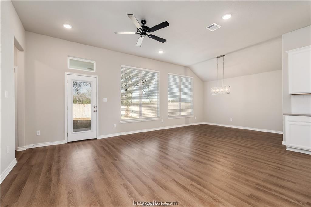 3185 Normandy Way Bryan, TX 77808 - Photo 4 of 16 a view of an empty room with wooden floor and a window