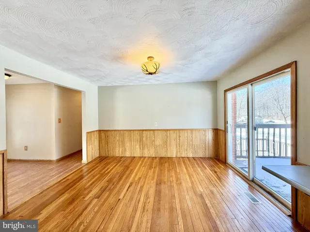 a large kitchen with a large window and stainless steel appliances