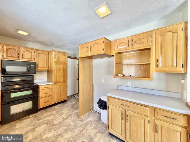 a kitchen with stainless steel appliances a sink stove and microwave