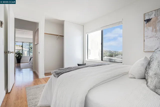 a bedroom with a large bed and a window