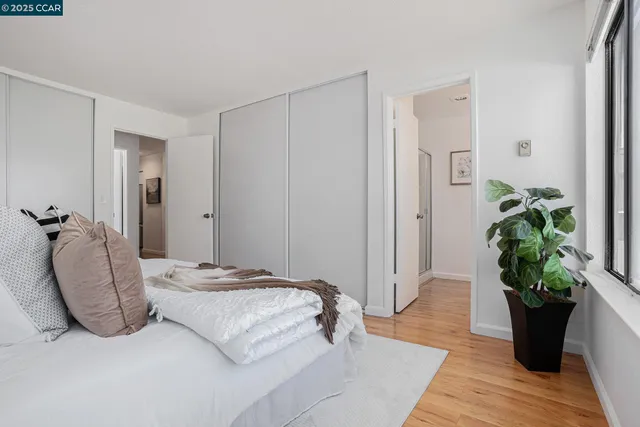 a bedroom with a bed and a potted plant