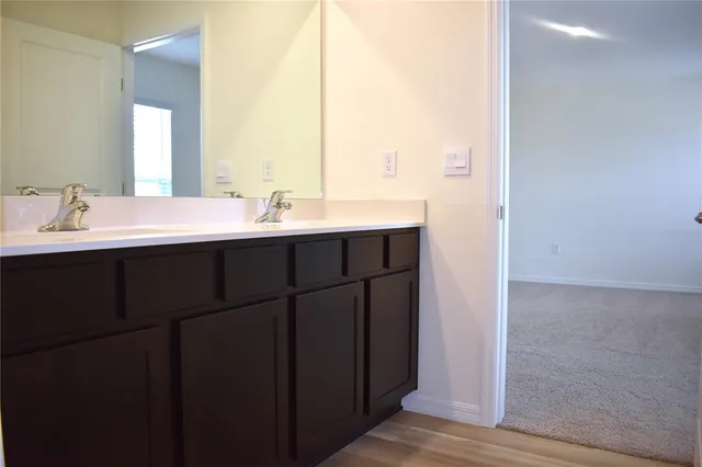 a bathroom with a double vanity sink and a mirror