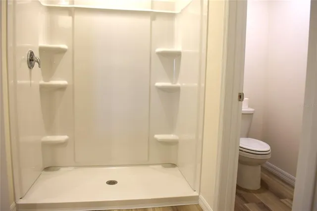 a bathroom with a shower and a toilet