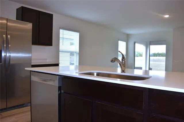 a kitchen with a sink and a refrigerator