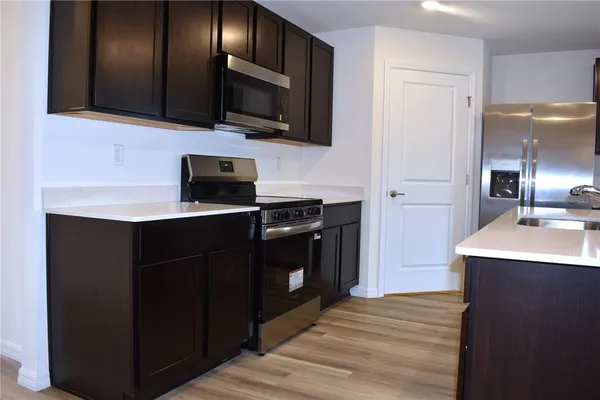 a kitchen with a sink stainless steel appliances and cabinets