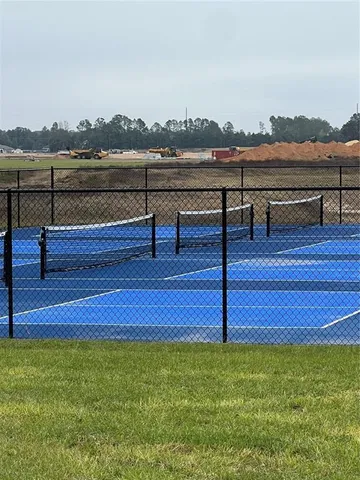 a view of a terrace with lawn chairs