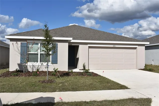 a view of house with backyard and garden