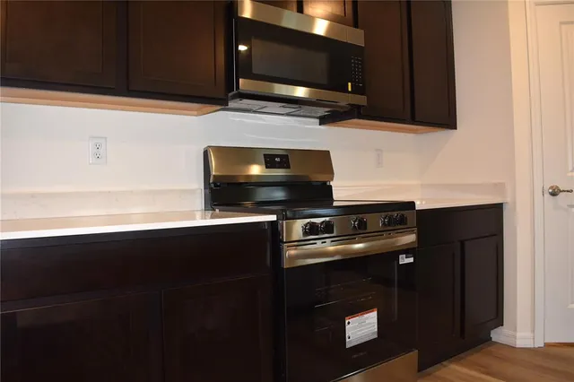 a kitchen with a stove microwave and sink