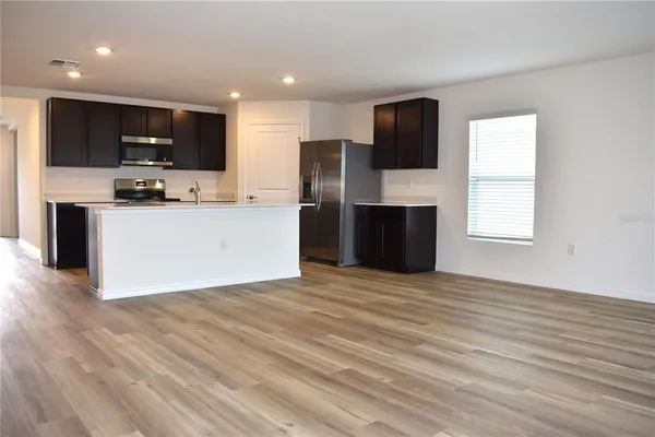 a view of a kitchen with microwave and cabinets